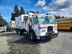 Salvage trucks for sale at Spanaway, WA auction: 2009 Peterbilt 320 Refuse Truck